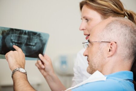 Dentist ckecking a wisdom tooth x-ray